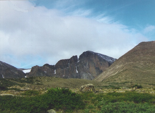 Longs Peak from the trail. The upper half of the Diamond is visible. The Loft is above the large snowfield to the left.