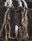 crw_6751 Serene standing between the roots of a silk cotton tree in Ta Prohm.