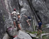 crw_5629 Jesse preparing to top rope a 5.10a slab, belayed by Martin. Adrian bouldering in the background with Ben observing.
